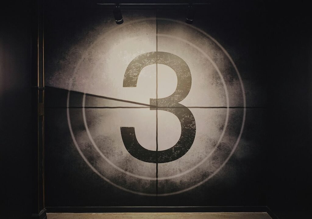 A vintage film countdown showing the number 3