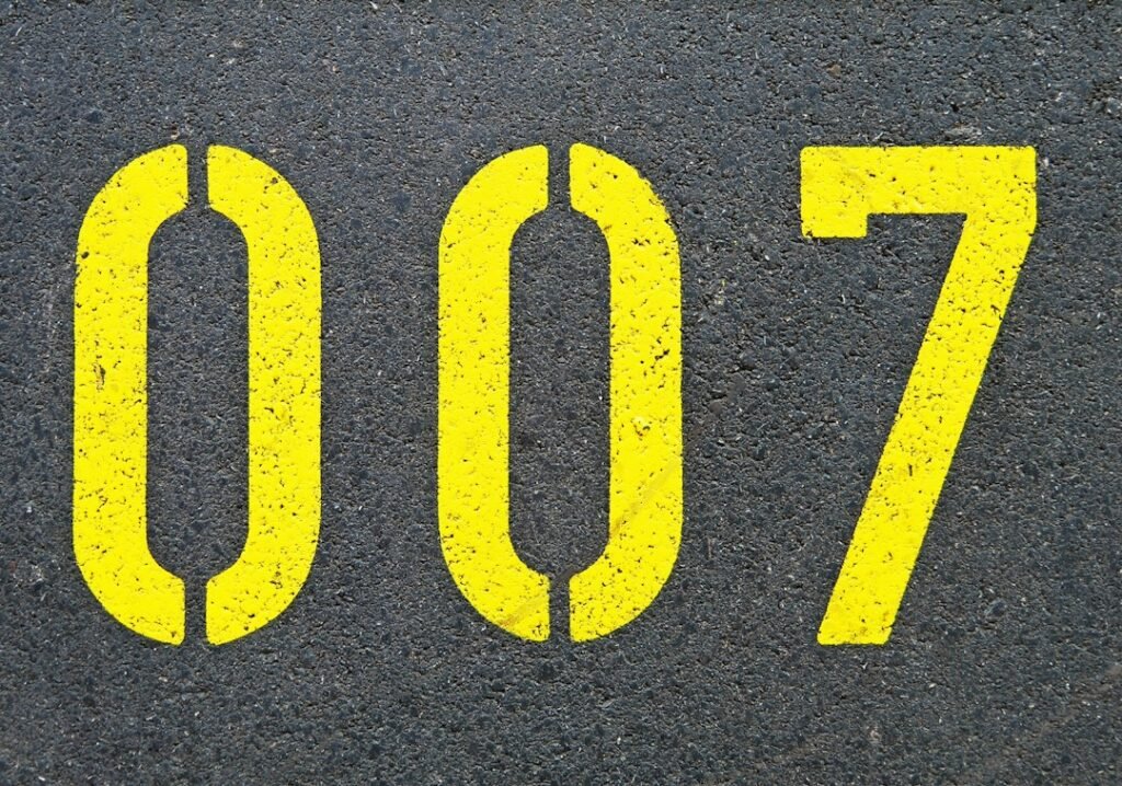 The numbers 007 stencilled in yellow on asphalt